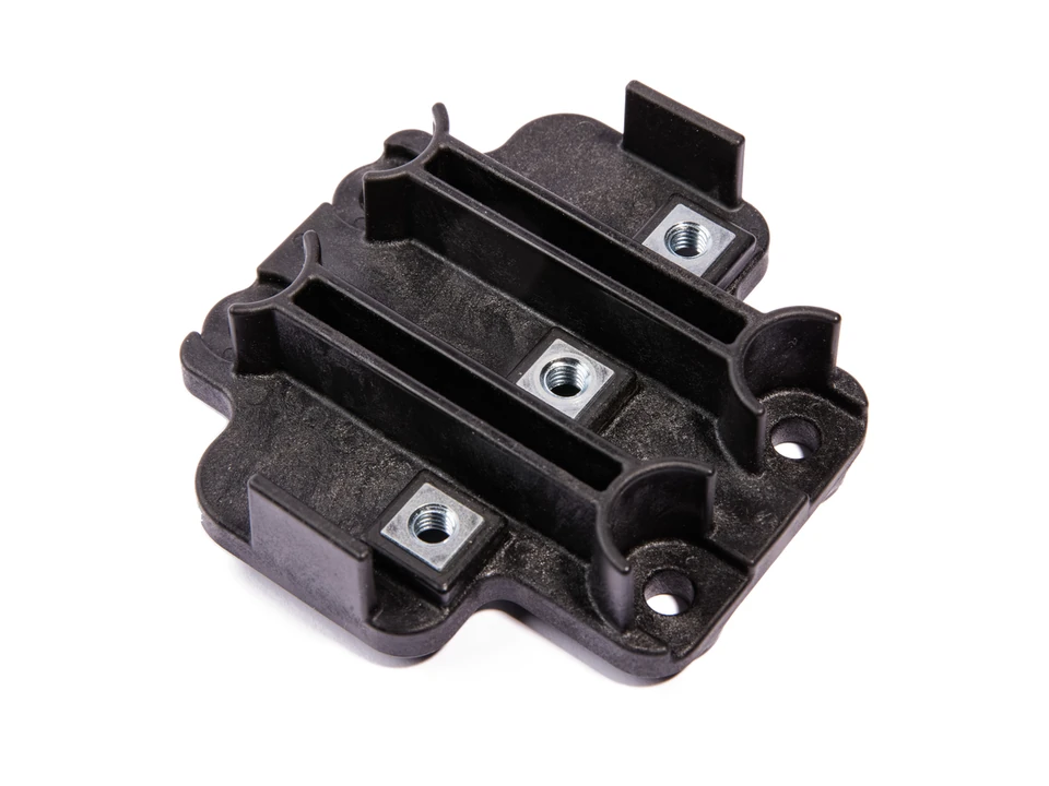 A black partitioned molded body with three square threaded metal inserts